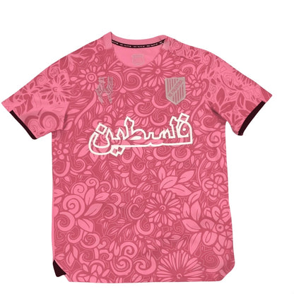 Lyserød FC Palestine football jersey med floral print og hvid arabisk Palestine tekst