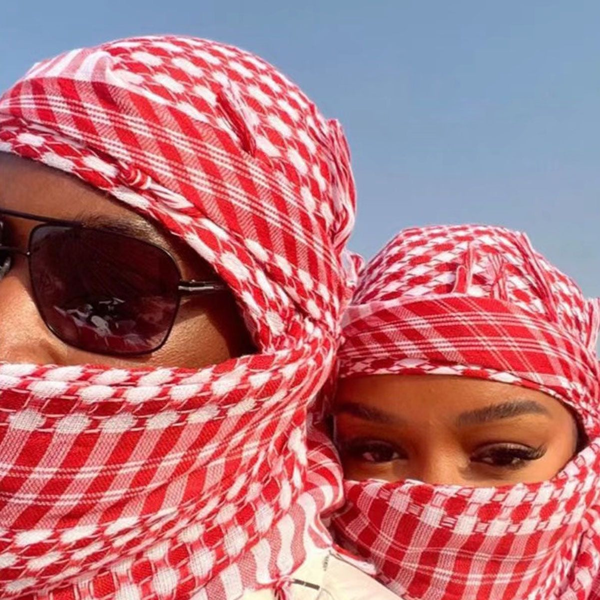 red kufiya worn as face cover